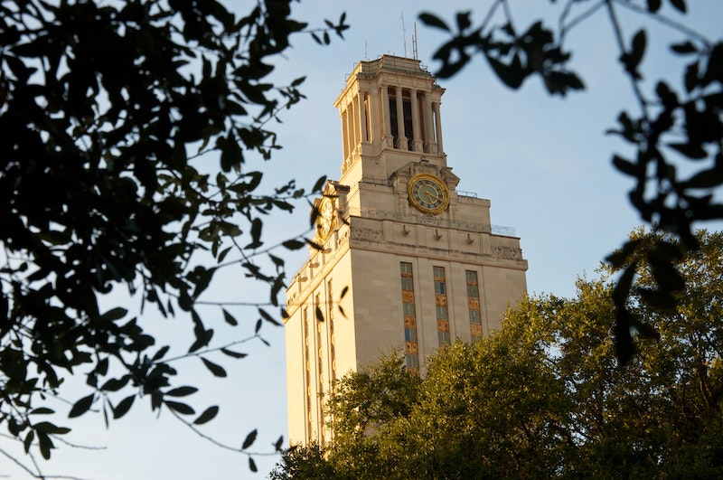 University of Texas tower photographed through trees branches